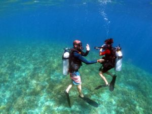 A scuba instructor teaching a new student