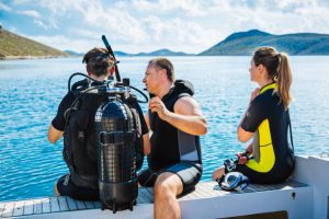 A scuba instructor giving advices to a novice diver