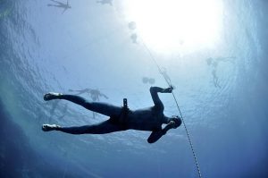 A scuba diver practicing equalization