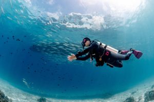 A diver diving in shallow water